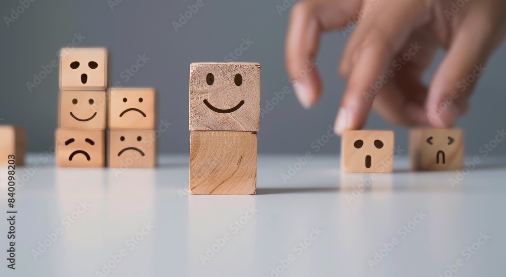 Poster a wooden cube block is moved up by hand with a smiley face indicating the customer is satisfied with