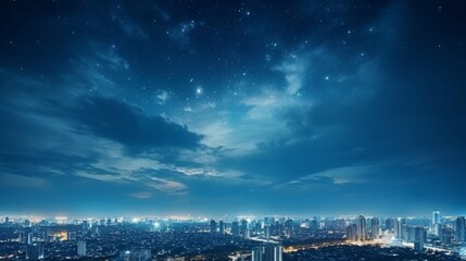 Nighttime view of a city skyline with stars and clouds