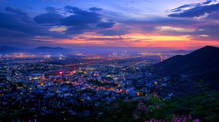 Fototapeta premium Cityscape panorama at sunset from a mountain viewpoint