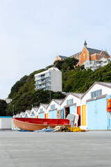boat houses in front of a church