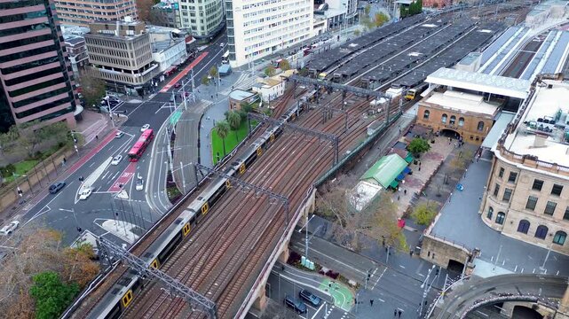 Landscape view of train leaving Central Station platform over busy street road bridge in Sydney Haymarket Surry Hills Australia transport travel