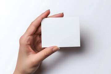 Obraz premium Business card mockup in woman's hand. Blank calling card template isolated on white background
