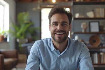 Fototapeta premium Man smile blue shirt sit bookshelf