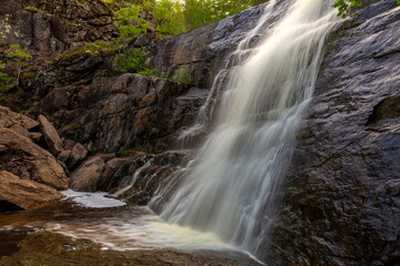 Obraz premium Gadelsha waterfall is the largest waterfall in the Southern Urals on a summer sunny day