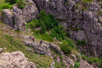 tourists men and women walk along the ridges of the Southern Urals on a summer day. Irendyk ridge