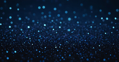 Obraz premium Shimmering blue glitter texture on a dark background, perfect for adding sparkle and shine to designs, invitations, or backgrounds