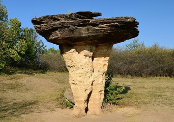 an eroded mushroom rock formation in the roadside attraction of  mushroom rock state park, near...