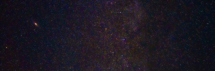 night starry sky with stars, milky way and galaxies on the background. Panorama, panoramic wide cover with copy space