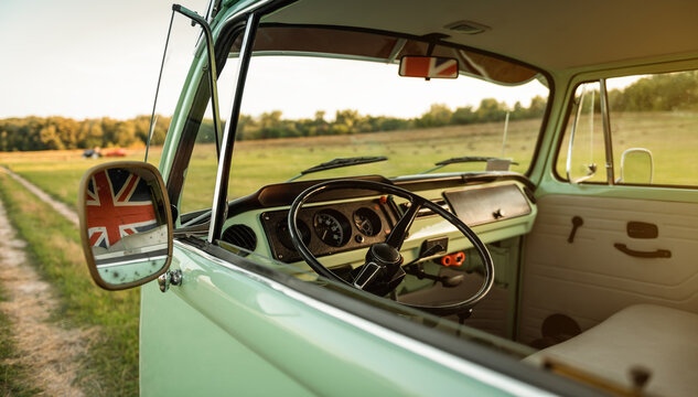 Interior of Volkswagen Transporter T2 classic bus. Countryside unpaved road in the background. Kyiv region, Ukraine - September 15 2015.