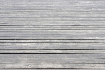 An old wooden gray pavement as a background. Photo in perspective