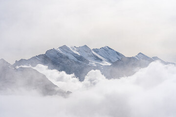 View of Swiss Alps over clouds on a bright sunny day from Schilthorn summit in Switzerland