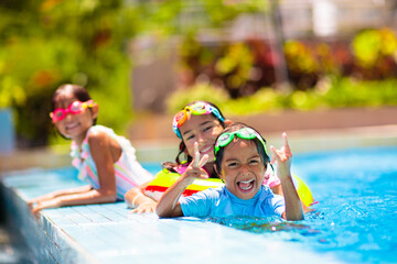 Kids in swimming pool. Children swim. Family fun.