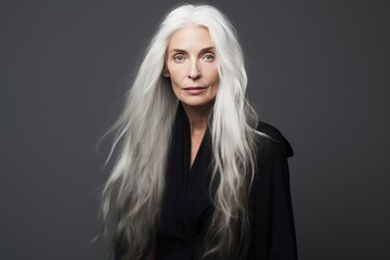 Non-binary person with long white hair wearing a black evening dress