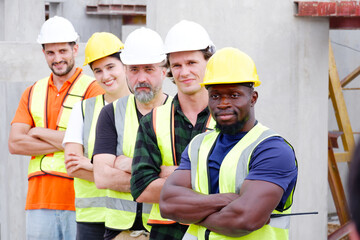 Engineer, industrial engineer standing smiling at work site.