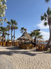 Sun loungers, umbrellas and tables on beach