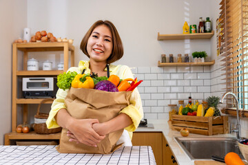 Asian housewife is showing variety of organic vegetables to prepare simple and easy japanese dish...