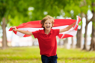 Child running with Austria flag. Austrian fan.
