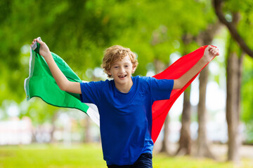 Child running with Italy flag. Italian fan.