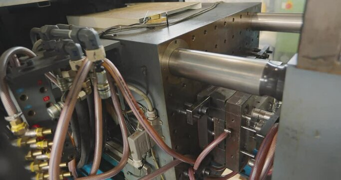 The process of creating a plastic part by injection molding. Injection molding thermoplastic machine.