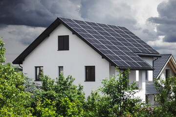 Solar Panels on Roof House with Storm Clouds in the Sky. Solar Energy Efficient. 