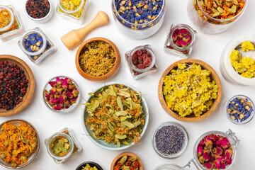 Assortment of dry herbal and berry tea on a wooden background. Tea party concept. medicinal herbs. Healing herbs.Alternative medicine.Linden, calendula, cornflowers, marigold, tansy, tea rose.