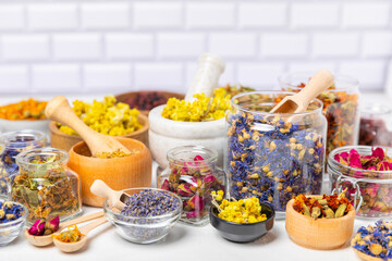 Assortment of dry herbal and berry tea on a wooden background. Tea party concept. medicinal herbs. Healing herbs.Alternative medicine.Linden, calendula, cornflowers, marigold, tansy, tea rose.