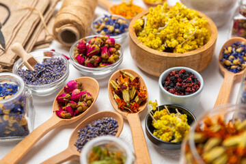 Assortment of dry herbal and berry tea on a wooden background. Tea party concept. medicinal herbs. Healing herbs.Alternative medicine.Linden, calendula, cornflowers, marigold, tansy, tea rose.
