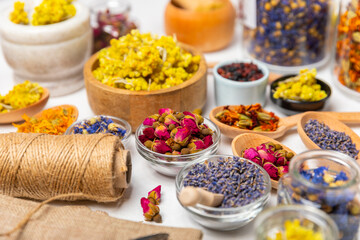 Assortment of dry herbal and berry tea on a wooden background. Tea party concept. medicinal herbs. Healing herbs.Alternative medicine.Linden, calendula, cornflowers, marigold, tansy, tea rose.