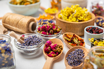 Assortment of dry herbal and berry tea on a wooden background. Tea party concept. medicinal herbs. Healing herbs.Alternative medicine.Linden, calendula, cornflowers, marigold, tansy, tea rose.