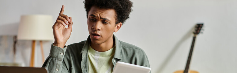 Young man engrossed in online study.