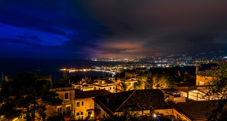 Beautiful view of night town of Italy with colorful golden lights, night landscape on city of Europe