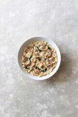 Orzo pasta with mushrooms and spinach. Italian Cuisine. Vegetarian food.