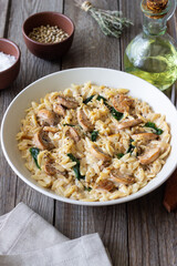 Orzo pasta with mushrooms and spinach. Italian Cuisine. Vegetarian food.