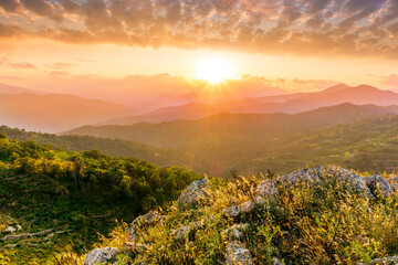 highland mountain landscape of beautiful sunset or sunrise with nice mountain peaks and slopes,...