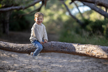 Little blonde boy having fun outdoors