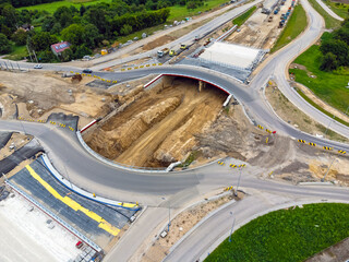 Aerial view landscape, view of traffic circle construction from above. Road workers finish the construction of the traffic circle.