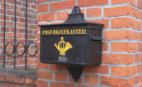 Vintage german post box with postilion horn symbol. Writing on box says mail box in German. 