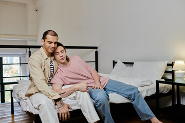 A young gay couple spends a quiet afternoon together, relaxing on a bed in a modern apartment.