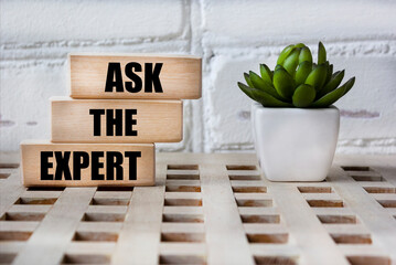 Set expert words on wooden blocks and beautiful background with flower. Consultation with a...