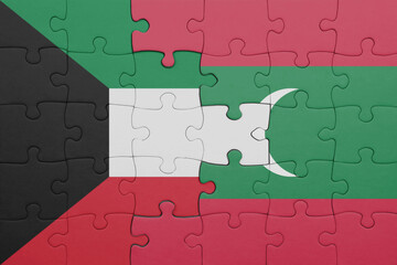 puzzle with the colourful national flag of maldives and flag of kuwait .