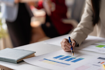 Close-up of a professional analyzing financial charts and graphs at the office, focused on growth trends and strategic planning.