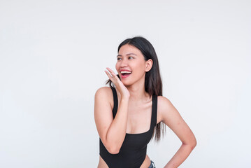 A fresh looking beautiful asian woman smiling and reacting to compliments, wearing a black...