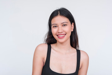 A fresh looking beautiful asian woman smiling, wearing a black tank top or bodysuit. Isolated on...
