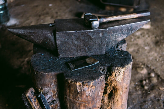 Traditional blacksmith tools on anvil in workshop