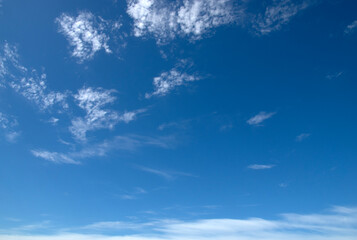 White fluffy clouds in the blue sky.