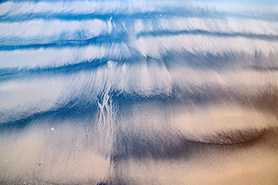 Captivating aerial view of abstract sand, coal and water patterns