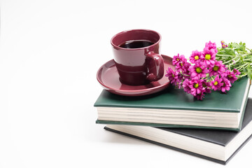 cup of coffee and book,Books and flowers on a white background,Beautiful pink flowers and cup of coffee on a stack of books