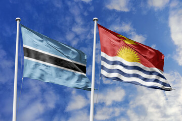 Fototapeta premium 3D illustration. Botswana and Kiribati flags waving in the sky. High detailed waving flag. 3D render. Flags fluttered in the cloudy sky, symbolizing diplomatic relations.