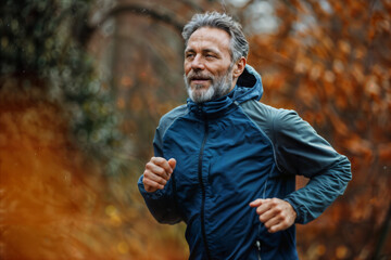 Obraz premium Mature Man Jogging in Autumn