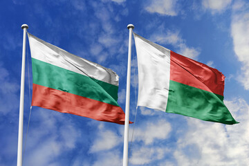 3D illustration. Bulgaria and Madagascar Flag waving in the sky. High detailed waving flag. 3D render. Waving in the sky. Flags fluttered in the cloudy sky.